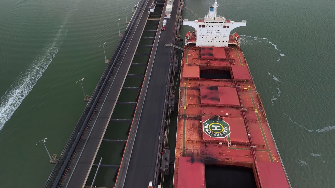 Aerial tilts from coal freighter to Gladstone terminal pier, Australia