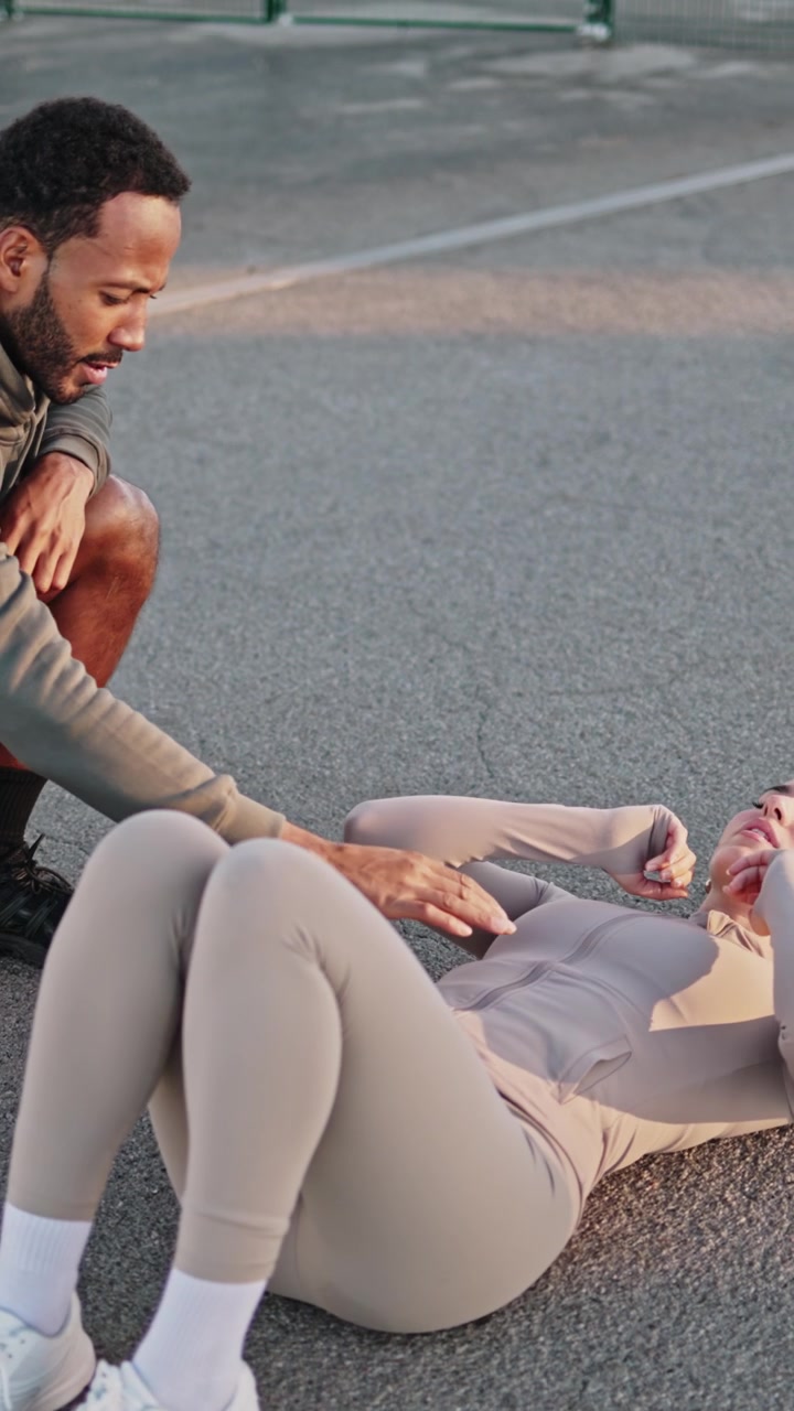 Personal Trainer Coaching Woman Doing Sit-Ups Outdoors