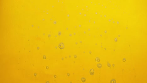 foam bubbles from soap flowing on yellow background.