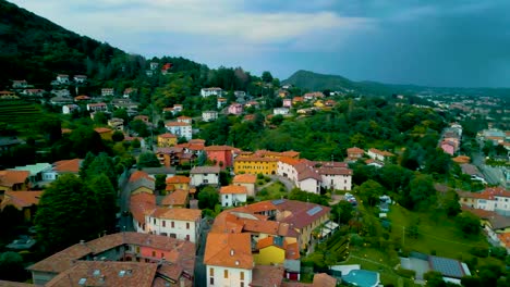 4k aerial drone video of mountainside farmhouses in cavallasca, italy on a summer evening
