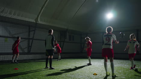 girls soccer team practicing indoors