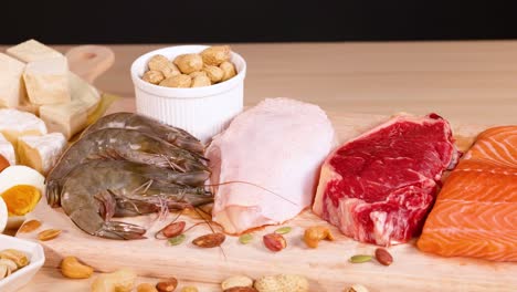 variety of meats and nuts on wooden board