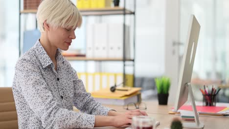 businesswoman working at computer in modern office