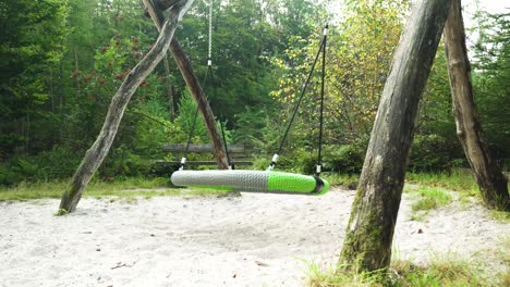 wooden tire swing in a forest playground