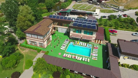Aerial view of a resort complex with swimming pool and activities