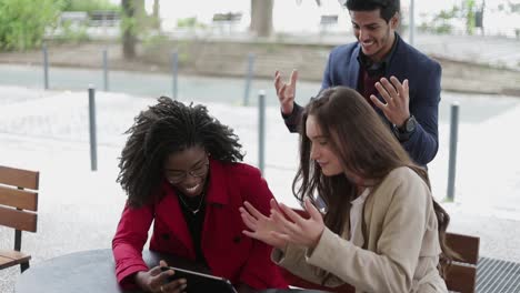 people looking at tablet, finding problem solution, saluting