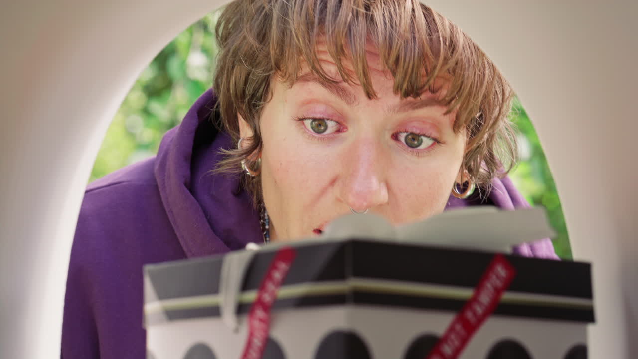 Excited Woman Retrieving Sealed Gift Box from Mailbox