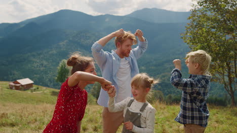 Parents-giving-five-children-on-meadow.-Family-gesticulating-playing-on-nature.