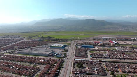 boom up aerial view of several housing complexes next to la serena airport with the mountain in the background, chile