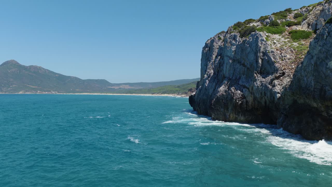 Scenic coastline view in Sardinia with clear blue sea and rocky cliffs