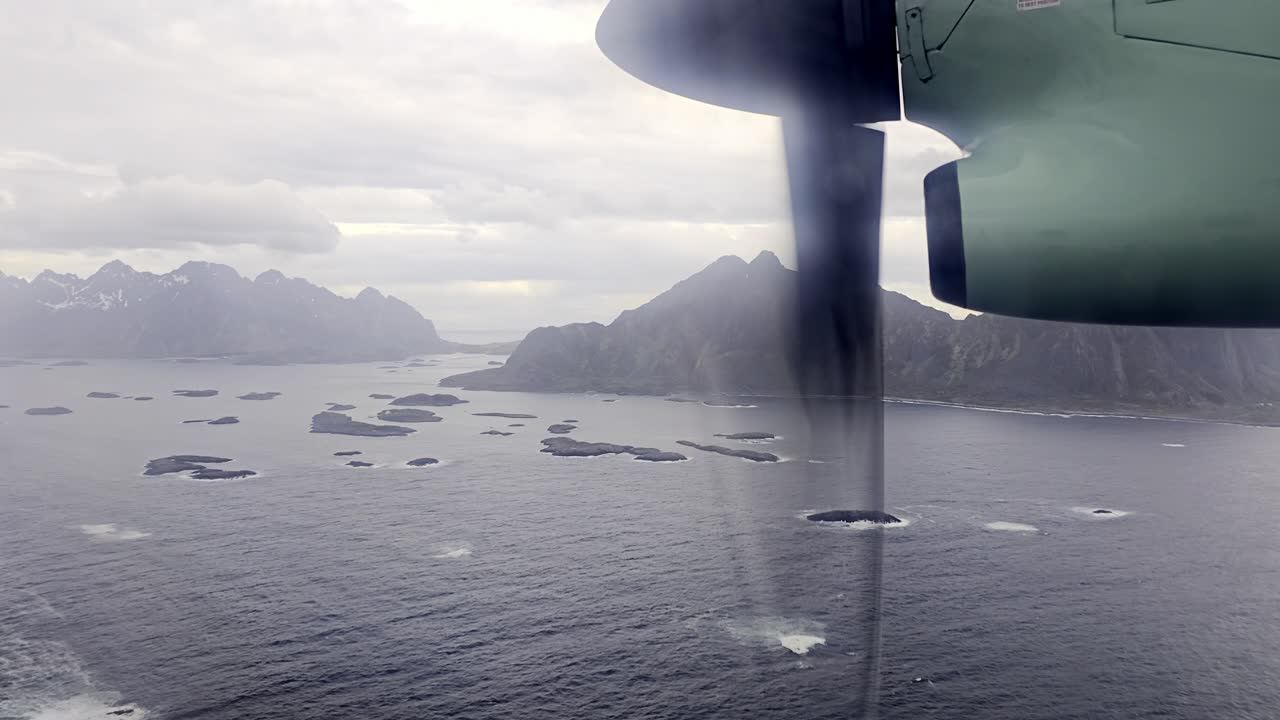 Window view from Wideroe flight over Vestfjorden, many small islands and mountains, early spring