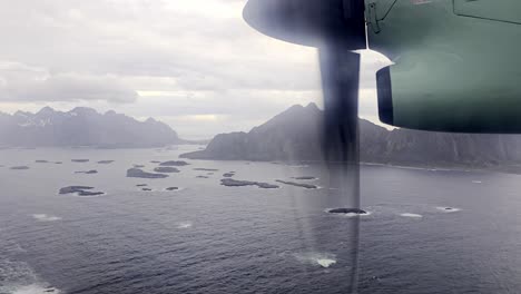 window view from wideroe flight over vestfjorden, many small islands and mountains, early spring