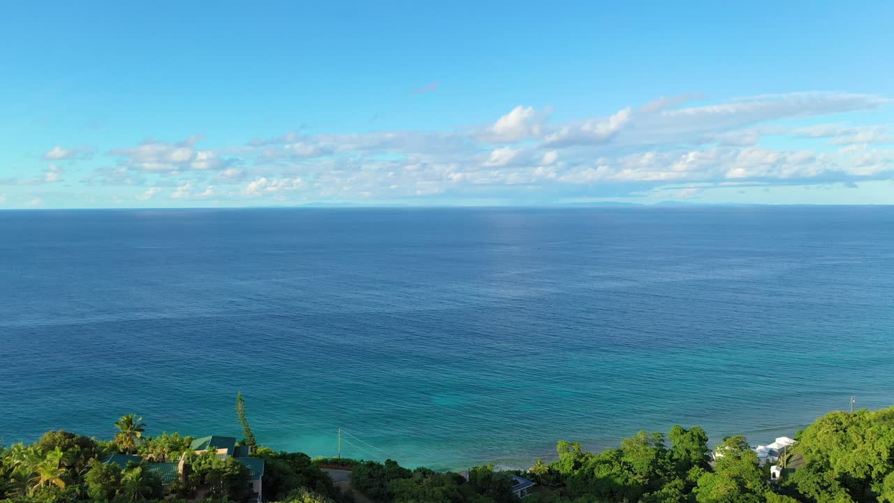 Overhead drone view of vast ocean waves breaking into white foam, deep blue sea stretching beyond the horizon, an inspiring and cinematic natural seascape for stock video projects