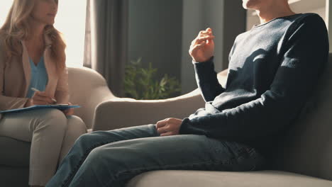 male patient in the consultation of a female psychiatrist who takes note of his mental health diagnosis 1