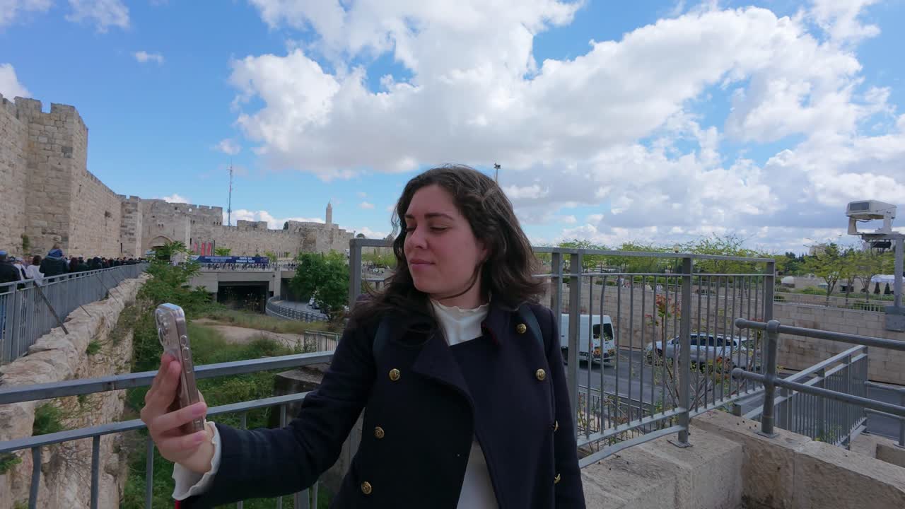 Tourist taking selfies in Jerusalem old city. Slow motion.
