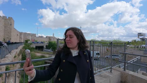 tourist taking selfies in jerusalem old city. slow motion.