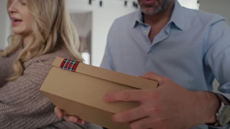 family sharing the christmas presents together at home.