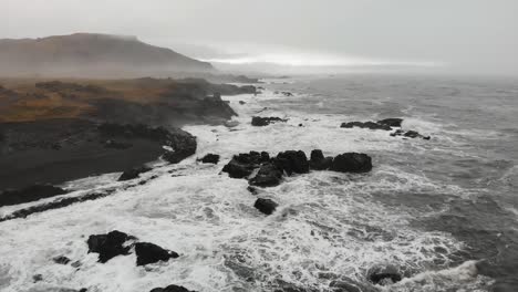 aerial footage over a black beach in djupavogshreppur, iceland-6