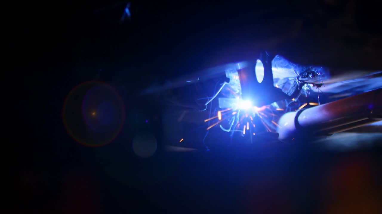 Male mechanic using flaming torch 4k
