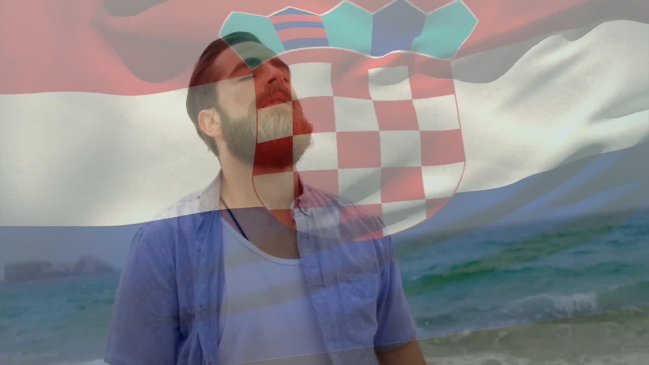 Standing by ocean, man with Croatian flag animation overlay in scenic view