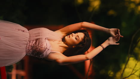 Beautiful-woman-with-arms-raised-gracefully-posing-wearing-pink-bridal-dress