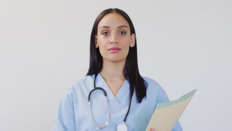 Animation-of-happy-biracial-female-doctor-looking-at-camera