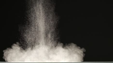 the stream of particles on the black background. slow motion