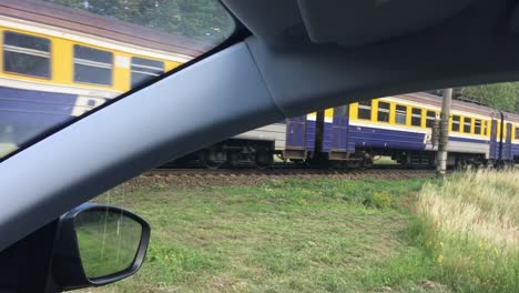 A-shot-of-a-train-passing-from-inside-a-car-in-latvia