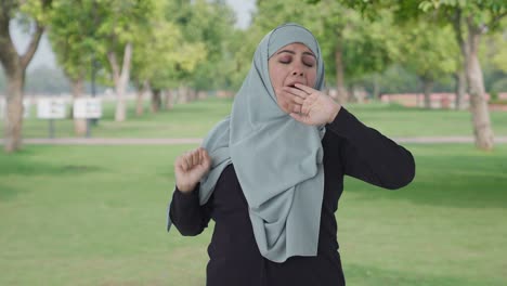 sleepy and tired muslim woman in park