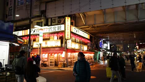 pedestrians walking through a vibrant night market