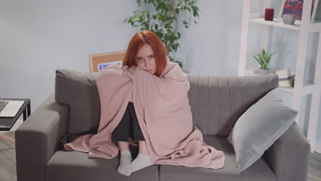 redhead woman watches interesting serial on tv in room