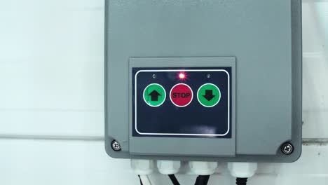 remote control of opening roller shutters. a man presses the button. close-up