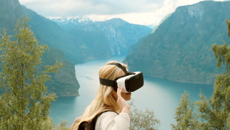 woman wearing vr headset in a fjord landscape