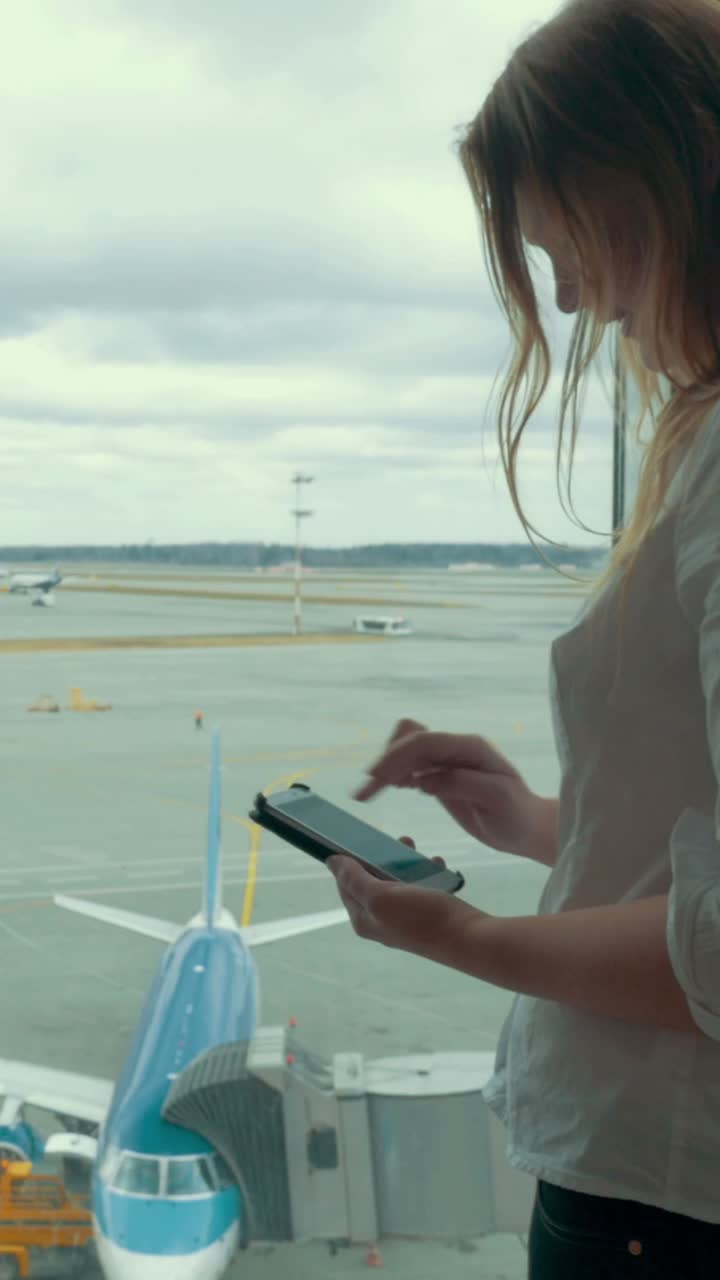 Woman at Airport Using Phone