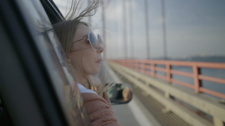 Girl looking through open car window