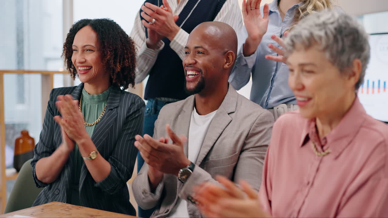 Diverse team of business professionals celebrating success in the office