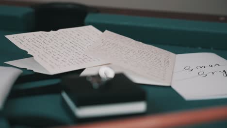 selective focus from beautiful weding groom cufflinks to vows letters in background