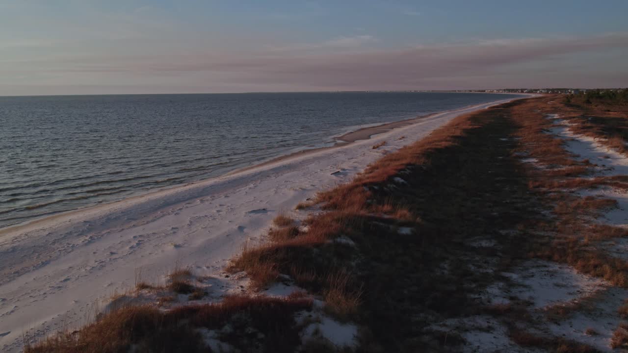Lot dronem wzdłuż ustronnej plaży o zmierzchu