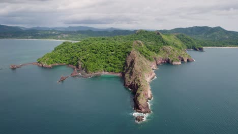 a 4k drone shot of punta sabana point and the mirador conchal peninsula next to puerto viejo and playa conchal, or “shell beach”, along the north-western coast of costa rica