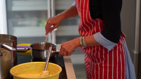 woman with apron cooking in the kitchen. - crop shot