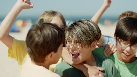 Close-up-shot-of-soccer-team-players-rejoicing-winning-on-beach