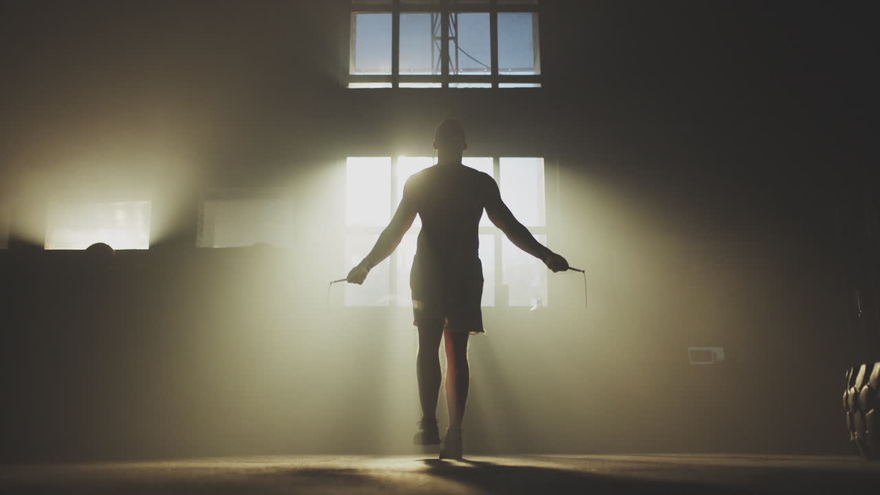 Man Jumping Rope in a Warehouse