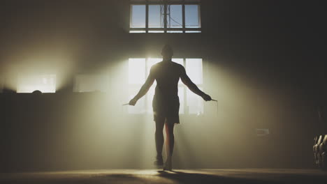 Man Jumping Rope in a Warehouse