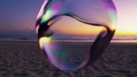 iridescent bubble at sunset on a sandy beach