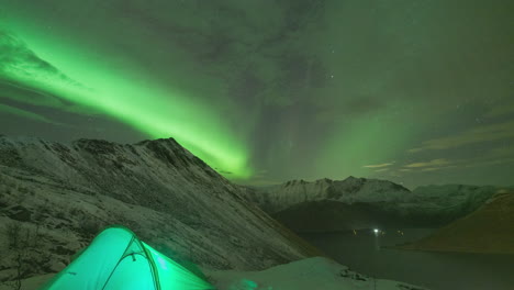 camping under aurora borealis polar night sky at the norwegian mountains