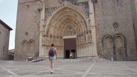 tourist visiting the santa maria de castelló in in castellon de ampurias, costa brava, spain -wide