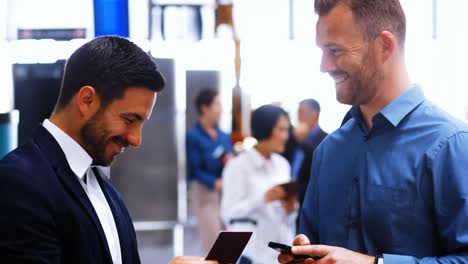 two male commuters interacting with each other