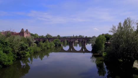 el viejo puente de montauban francia cruzando el río tarn con tráfico de automóviles, toma aérea de aproximación
