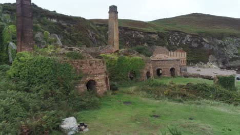 Porth-Wen-aerial-right-orbit-view-abandoned-Victorian-industrial-brickwork-factory-remains-on-Anglesey-eroded-coastline