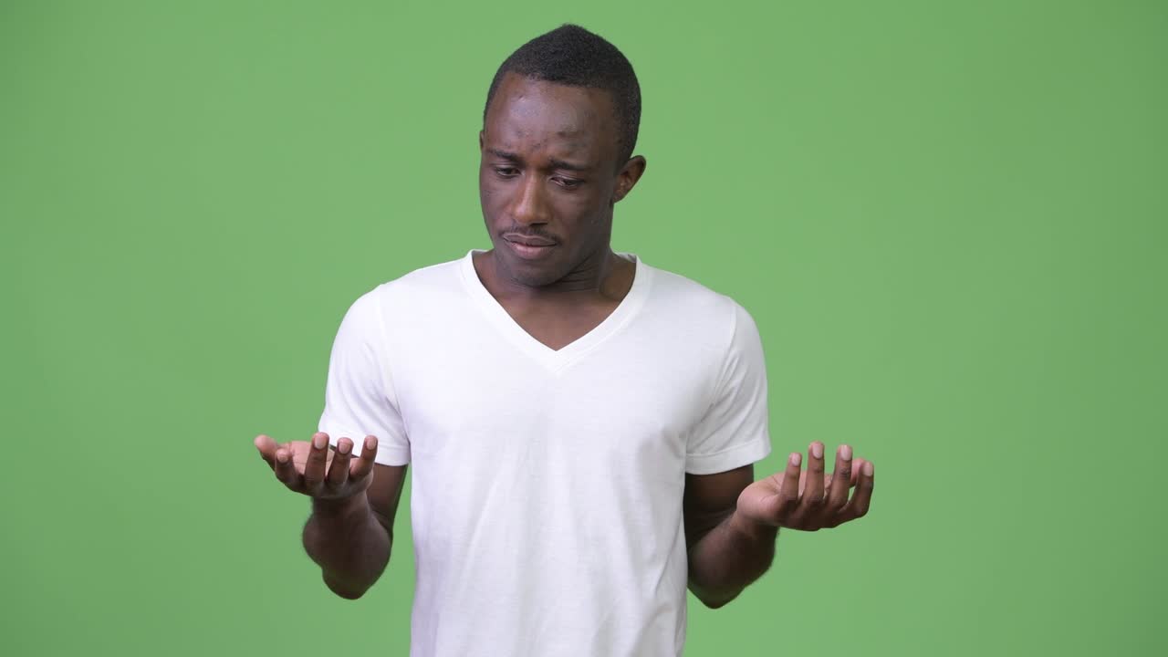 Young sad African man shrugging shoulders